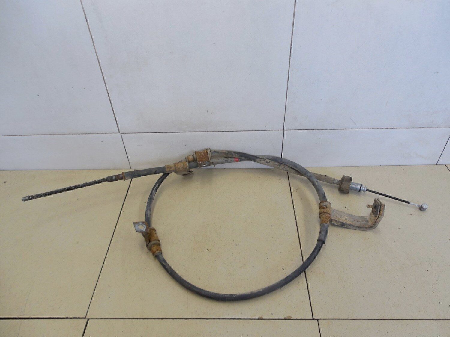 Трос стояночного тормоза левый KIA RIO 2005-2011